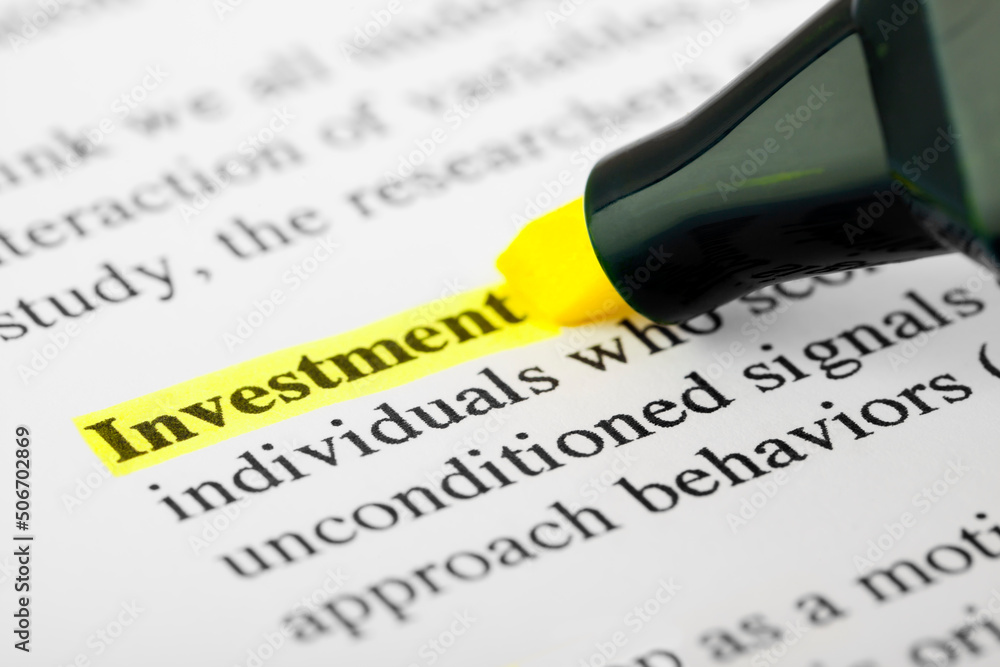 Investment Text Macro Shot Highlighted in Yellow Color On Printed Paper Investment Text Macro Shot Highlighted in Yellow Color On Printed Paper