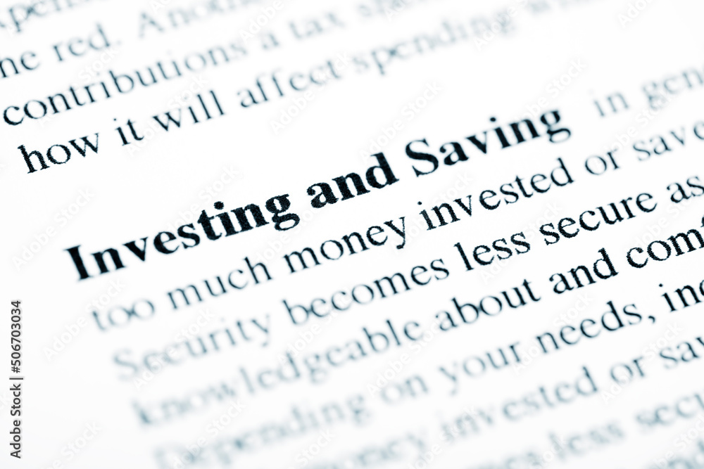 Investing and Saving Text Macro Shot On Printed Paper Investing and Saving Text Macro Shot On Printed Paper