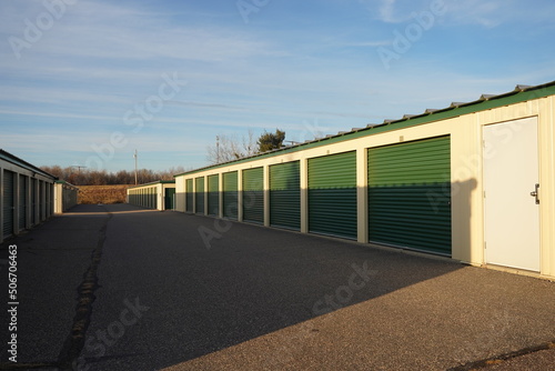 Green and tan storage units service the community to hold the owner's property. © Aaron