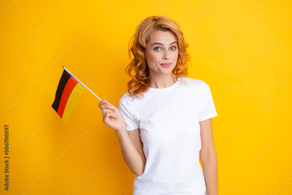 Portrait of happy student woman holding German flag. Isolated on yellow background. Happy girl holding flag of Germany, immigration and travelling in Europe. Deutschland, deutsche flag. Portrait of happy student woman holding German flag. Isolated on yellow background. Happy girl holding flag of Germany, immigration and travelling in Europe. Deutschland, deutsche flag.