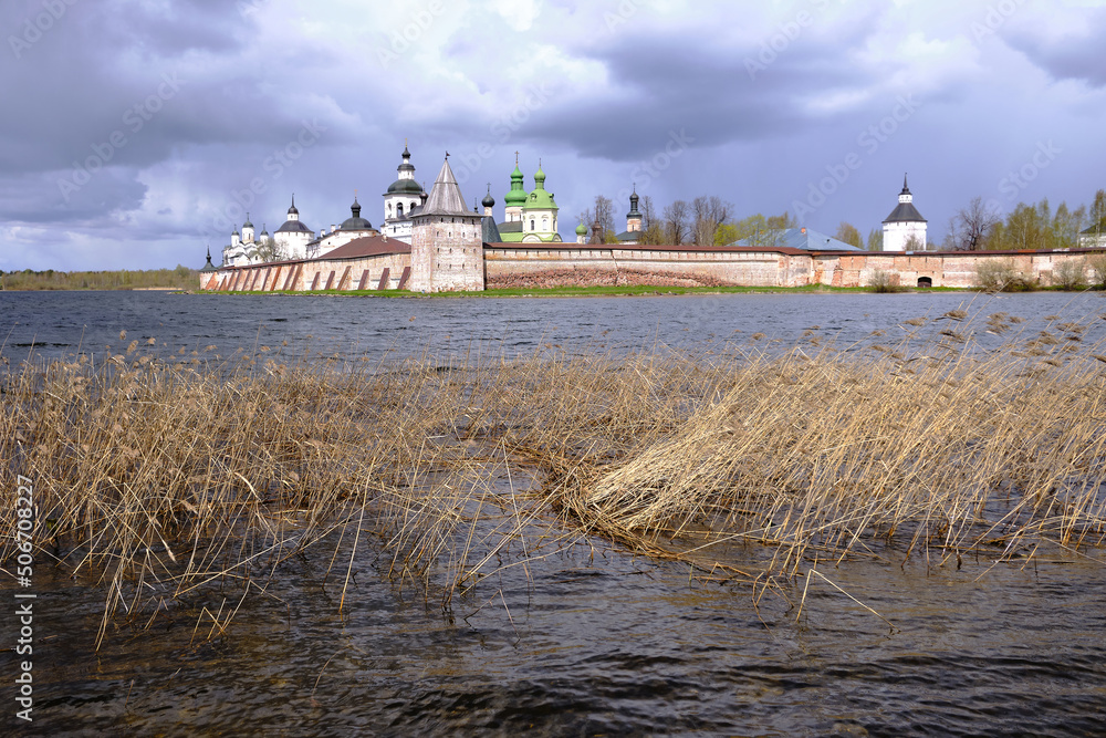 Fototapeta premium Beautiful landscape with a view of the ancient Orthodox monastery and the lake, cloudy weather