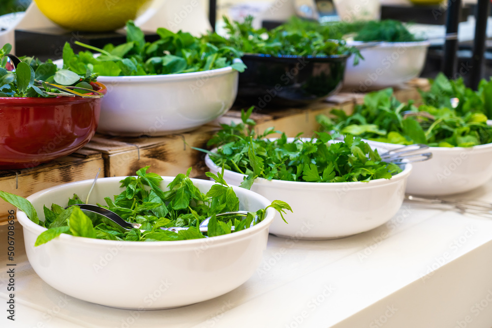 Salad bar with fresh greens in hotel buffet. Concept of healthy eating