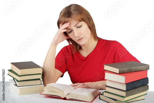 portrait of beautiful student girl sitting among the books