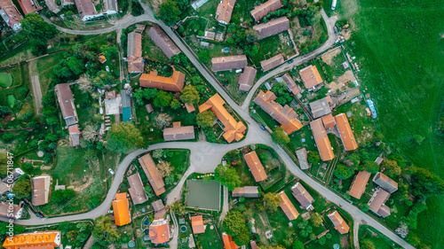 Aerial view of a small village.Top view of traditional housing estate in Czech. Looking straight down with a satellite image style.Houses from above, real estate concept.Country road urban scene