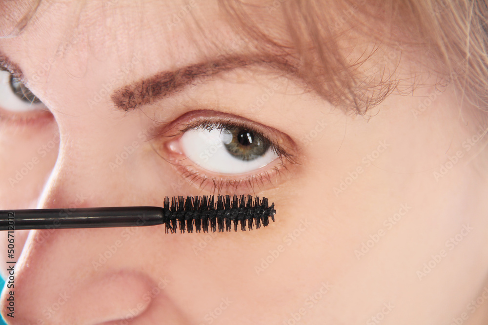Woman eye with  eyelashes. Mascara Brush