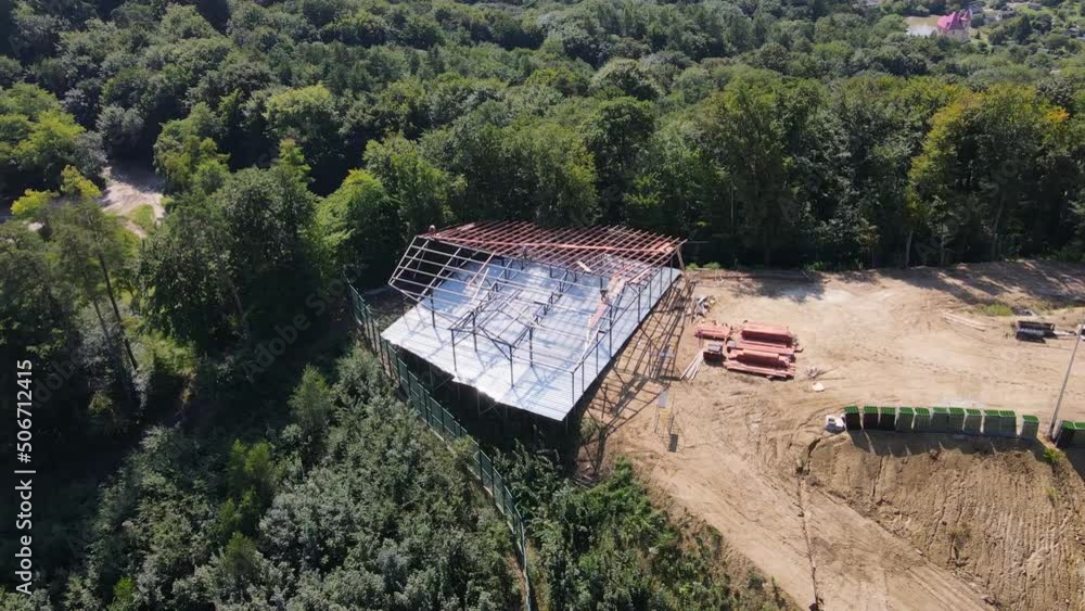 View from above on the construction of a small restaurant or house in the woods and nature. Craftsmen build the frame of a house in the woods on the mountain View from above on the construction of a small restaurant or house in the woods and nature. Craftsmen build the frame of a house in the woods on the mountain