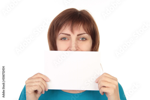 Smiling Woman Holding Empty White Poster Advertising Something Standing On Gray Studio Background. Mockup