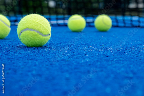 five balls on a paddle tennis court, selective focus © Vic