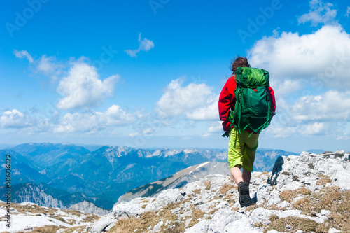 Hiker on mountain. Hochschwab Mountains. The mountain range is located in the eastern part of the Northern Alps in the Austrian state of Styria. Tourist with a backpack and mountain panorama photo