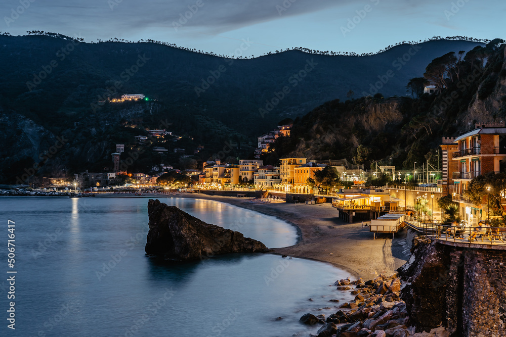 Evening view of Monterosso and landscape of Cinque Terre,Italy.UNESCO Heritage Site.Picturesque colorful coastal village located on hills.Summer holiday,travel background.Italian Riviera.Night town