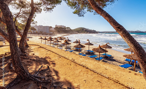 deserted morning sea beach with sunny screens. Platja Gran de Torà photo