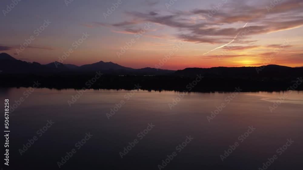 Sunset with lake and mountain landscape pan, silhouette painting vibe Sunset with lake and mountain landscape pan, silhouette painting vibe