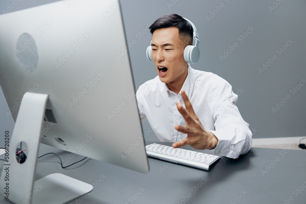 businessmen in a white shirt with headphones sits in the office isolated background businessmen in a white shirt with headphones sits in the office isolated background