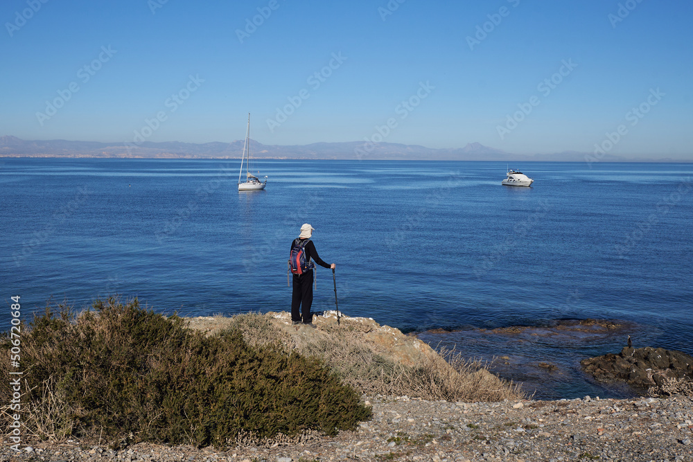 Hiker in the Tabarca island with the sea to the background. Alicante, Spain