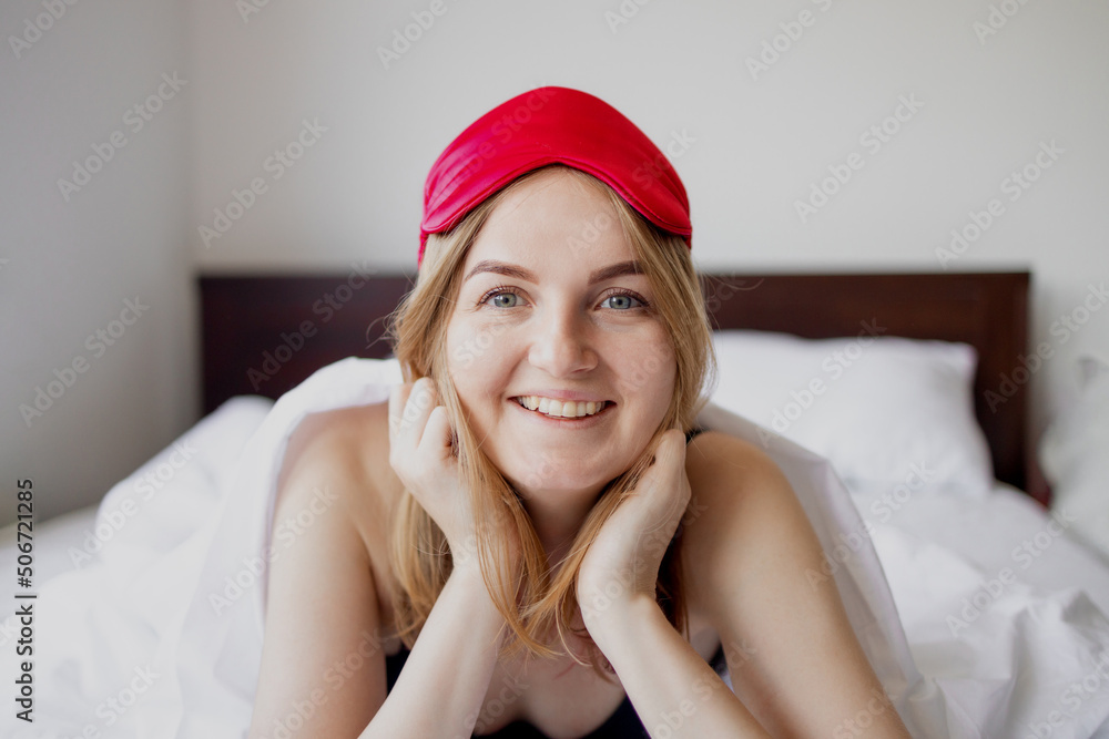 Young beautiful girl smiling after wake up in her bed with white bedclothes early in the morning. Young beautiful girl smiling after wake up in her bed with white bedclothes early in the morning.