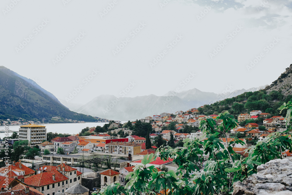 View of the city of Kotor from the mountain Ladder of Kotor, San Giovanni castle view. Mountains sea and bay. Brown rooftops of the city