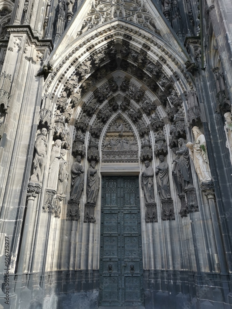 Entrance portal of a church with many saints and blessed