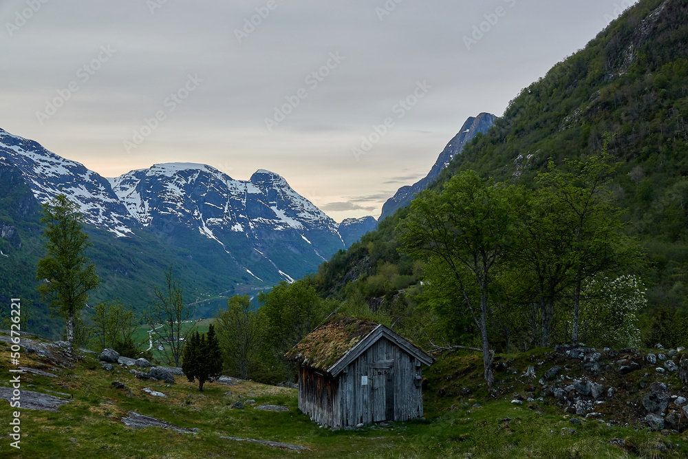 Briksdalasbreen glacier. Sunset. Glacier waterfall. Sheep. Authentic Norwegian house. Spring in Norway. Jostedalsbreen National Park.
