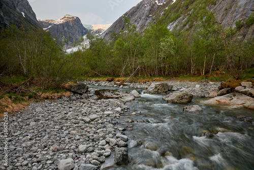 Briksdalasbreen glacier. Sunset. Glacier waterfall. Sheep. Authentic Norwegian house. Spring in Norway. Jostedalsbreen National Park.