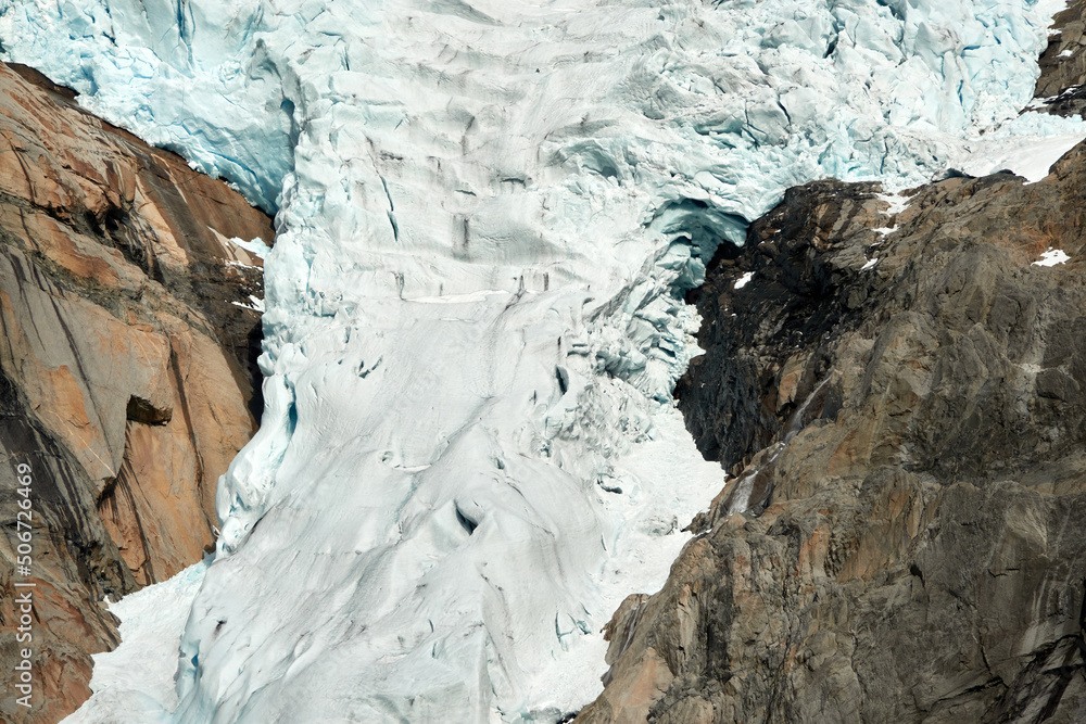 Naklejka premium Briksdalsbre glacier. Late afternoon. Fast stream. Glacier waterfall. Spring in Norway. Jostedalsbreen National Park.