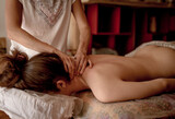 Close-up of hands of a masseur massaging back of a young woman, traditional chinese medicine.