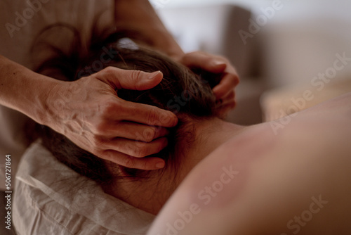 Fotografie Close-up of hands of a masseur massaging back of a young woman, traditional chinese medicine