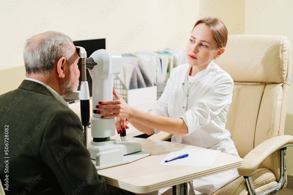 ophthalmologist examination of elderly man on corneo topographer.modern clinic ophthalmologist examination of elderly man on corneo topographer.modern clinic