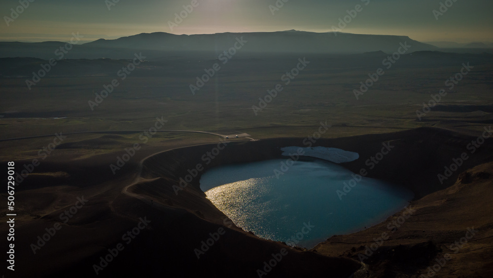 Aerial drone view of Viti crater in Krafla area of Iceland viewed from one of the outlook posts, on a nice summer evening, with sun slowly setting down.