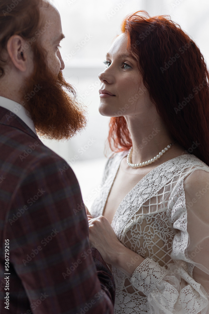 Beautiful red hair bride in a white wedding dress and bouquet of