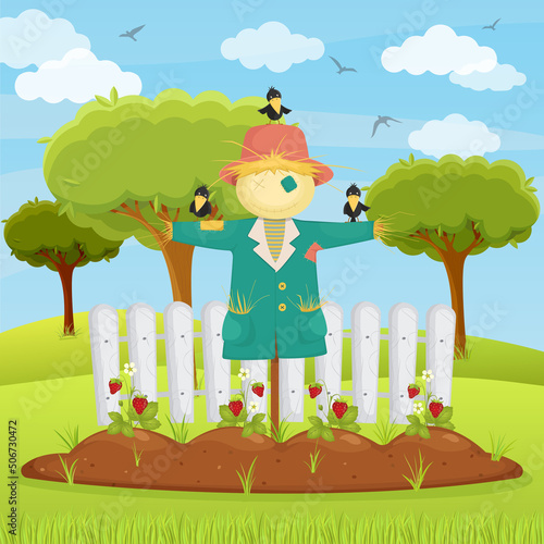 Strawberries in a garden bed with a scarecrow and crows. Landscape of a summer village, agriculture.