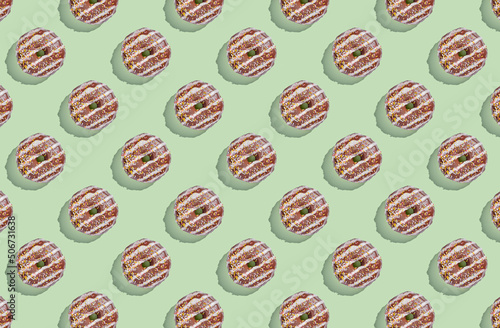 Pattern of donuts on green pastel background