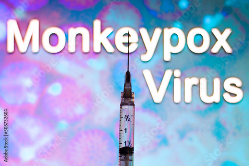 A medical syringe with the word Monkeypox virus in the background. Monkeypox is a viral disease that occurs mainly in central and western Africa. photo