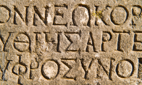 Ancient archaeology with ancient greek inscriptions and letters on stone. 