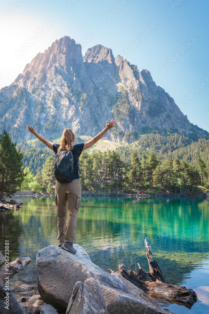 Naklejka premium Young Attractive Woman With Open Arms hiking in a Beautiful Lake in summer. Discovery Travel Destination Freedom Concept