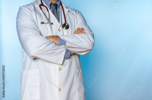 doctor in white coat and stethoscope with crossed arms