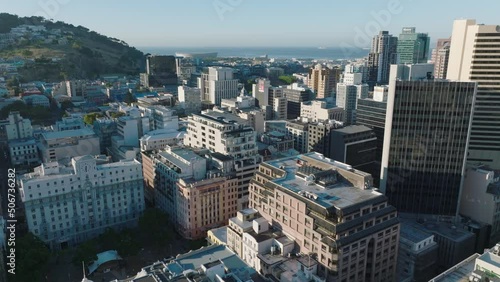 Fly about modern high rise buildings in city centre. Sea in Table Bay in background. Cape Town, South Africa