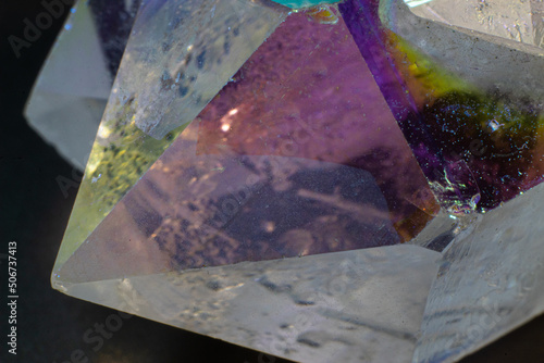 Colourful Angel Aura Quartz crystal point cluster on black surface