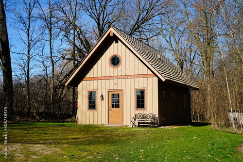 Historical old vintage abandoned mini stone church stands enclosed around a forest out in the countryside