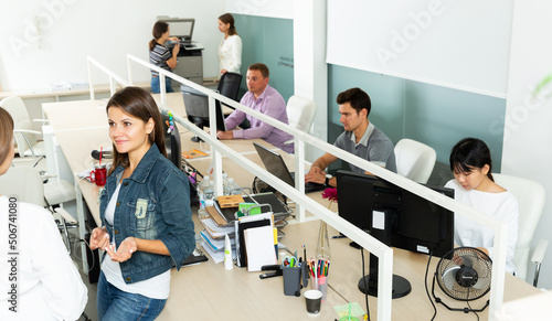 Multiracial group of successful business positive people during daily work in modern informal office space
