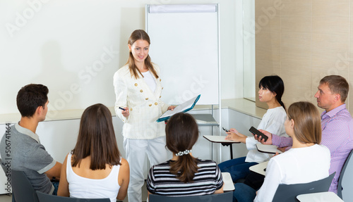 Confident young businesswoman presenting new business project to partners in modern office..
