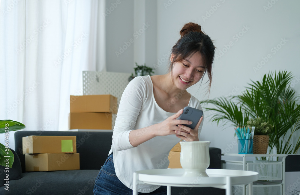 Startup small business entrepreneur receive order on mobile phone while working at home office. Startup small business entrepreneur receive order on mobile phone while working at home office.