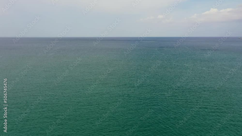 Beautiful white clouds on blue sky over calm sea. Tranquil sea harmony of calm water surface. Beautiful white clouds on blue sky over calm sea. Tranquil sea harmony of calm water surface.