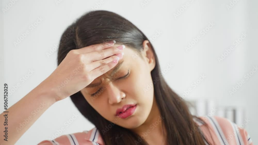 Asian beautiful upset depressed girl sitting alone on sofa in bedroom. Asian beautiful upset depressed girl sitting alone on sofa in bedroom.