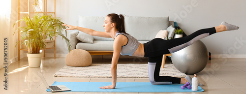 Sporty young woman doing pi...