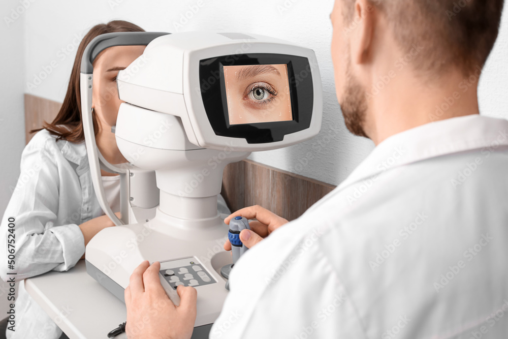 Ophthalmologist examining young woman in modern clinic Ophthalmologist examining young woman in modern clinic