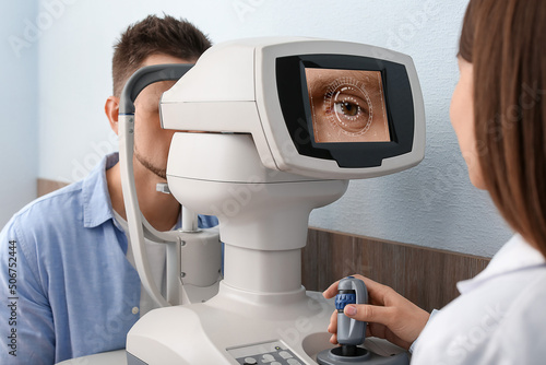 Ophthalmologist examining man in modern clinic