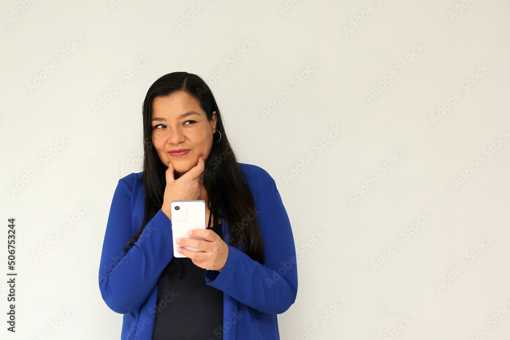 Latin adult woman with straight black hair and a blue jacket sends and receives messages from her cell phone very excited and happy makes purchases online in app
Latin adult woman with straight black hair and a blue jacket sends and receives messages from her cell phone very excited and happy makes purchases online in app