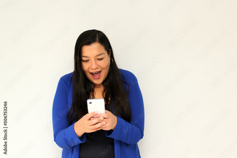 Latin adult woman with straight black hair and a blue jacket sends and receives messages from her cell phone very excited and happy makes purchases online in app
Latin adult woman with straight black hair and a blue jacket sends and receives messages from her cell phone very excited and happy makes purchases online in app
