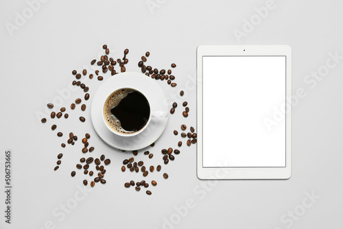 Tablet computer and cup of ...