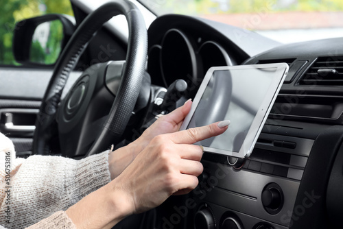 Female driver using tablet computer for navigation